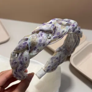 Detailed view of a purple floral pleated headband featuring delicate rhinestone embellishments
