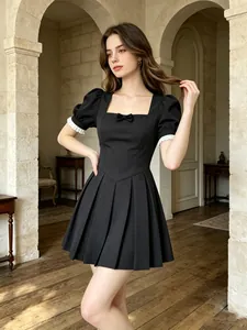 Detail view of a French vintage black dress with square neck and puffed lace sleeves