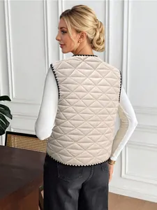 Back view of a women's cream quilted vest with black scalloped edges and diamond stitching