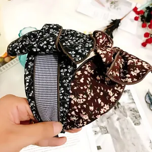 Detailed view of vintage floral oversized bow headbands with retro patterns and soft fabric.