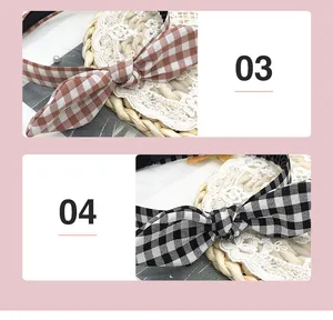 Close-up detail of brown and black gingham plaid bunny ear headbands in cute fabric style.