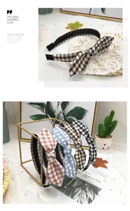 Detail view of stylish plaid bow headbands in various colors on a decorative display