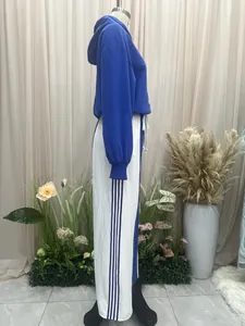 Side view detail of vintage blue and white color block sports hoodie and striped pants set