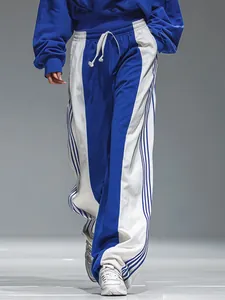 Close-up of retro blue and white color-block oversized tracksuit with striped wide-leg pants