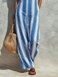 Close-up of elegant blue and white vertical striped linen jumpsuit for summer chic style