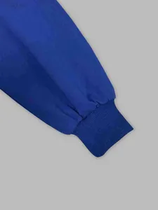 Detailed macro view of the elastic ribbed cuff on a blue vintage hooded sports sweatshirt