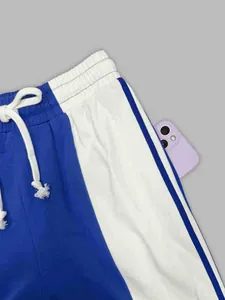 Close-up of retro blue and white striped sweatpants with drawstring and side pocket