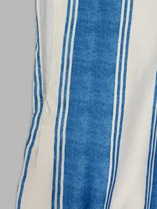 Close-up detail of hidden zipper on elegant blue and white striped fabric of summer romper
