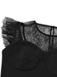 Detailed close-up of black lace ruffles and mesh on a sleeveless structured top