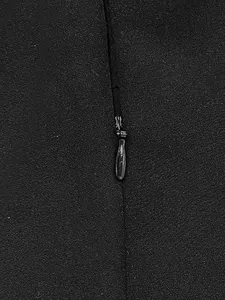 Detailed view showing the high-quality invisible zipper on a black sleeveless top