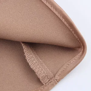 Close-up detail showing the fine stitching and satin texture of the elegant halter top