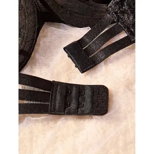 Close-up view of the adjustable triple hook-and-eye back closure on a black lace bra