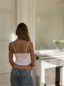 Back view of a white camisole with a charming red heart print and slim straps