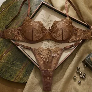 Detail shot of exquisite brown rose embroidery on elegant sheer sexy lingerie set