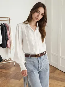 Elegant white blouse featuring lace trim, lantern sleeves, and pleated cuffs detail