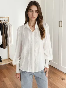 Detailed view of an elegant white lace-trimmed lapel shirt featuring lantern sleeves and ruffles