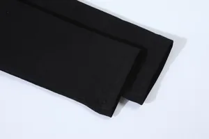 Detailed view of the black cotton sleeve cuff showing high-quality flatlock stitching