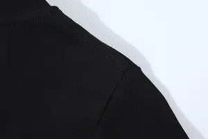 Detailed close-up showing the high-quality shoulder stitching on a black slim fit t-shirt.