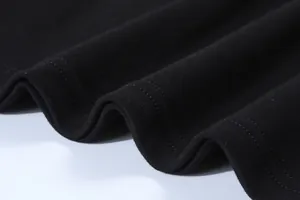 Close-up detail of black 230g cotton T-shirt hem with double-needle stitching