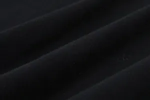 Close-up view of premium black 230g cotton fabric texture showing soft knit grain.