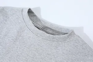 Close-up of the round neckline on a grey high-waist short long-sleeve T-shirt