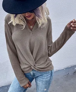 Detailed view of women's brown waffle knit long sleeve top with twist front knot design
