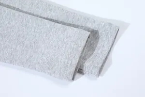 Macro detail shot showing the high-quality stitching on a grey cotton t-shirt sleeve cuff