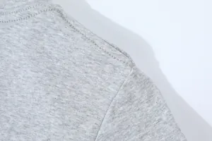 Close-up of the shoulder stitching and fabric texture of a grey slim-fit t-shirt