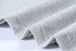 Macro detail of the double-needle stitching on a grey 230g cotton slim fit T-shirt.