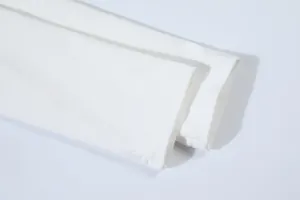 Detailed close-up of the neat double-stitched cuffs on a white ribbed knit long sleeve T-shirt.