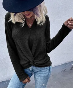 Detail of long sleeve waffle knit top with front knot and V-neckline