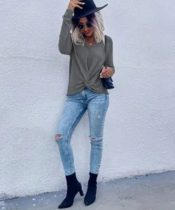 Casual grey knit top featuring a stylish front twist design and a classic V-neckline