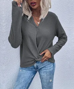 Detail shot of a dark grey waffle knit top with V-neck and stylish front knot.