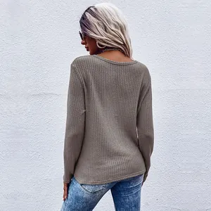 Back view of a khaki long sleeve waffle knit top with a casual minimalist design