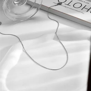 Macro view of minimalist silver stainless steel chain necklace with secure lobster clasp