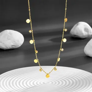 Close-up of a gold stainless steel necklace with circular discs and crystal accents