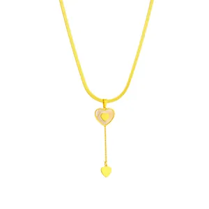 Dettaglio collana cuore in acciaio inox con intarsio in conchiglia e nappa d'oro.
