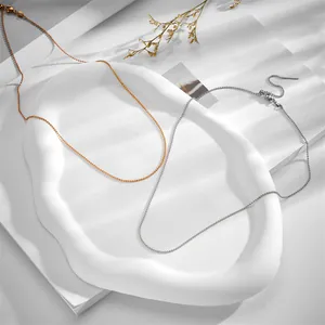 Detailed view of gold and silver stainless steel bead chains with adjustable needle slider