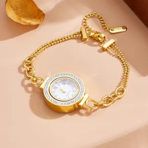 Detailed view of gold-tone titanium steel bracelet watch with crystal bezel
