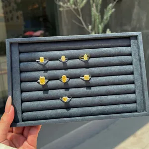 Collection of S925 silver rings with yellow crushed ice cut zircons on velvet tray