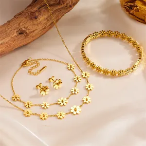 Elegant gold-toned titanium steel daisy jewelry set including necklace, bracelet, and earrings.