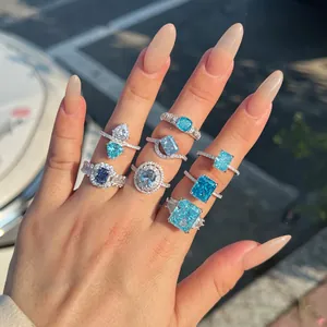 Close-up of sparkling S925 sterling silver rings with blue ice-flower cut zircons on hand.