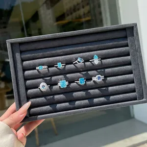 Detailed display of S925 silver rings featuring blue cubic zirconia with ice flower cut