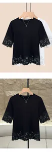 Elegant lace patchwork detailing on the hem and sleeves of a black round neck T-shirt.