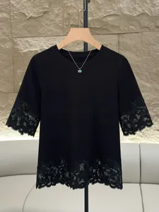 Elegant black crew neck T-shirt with intricate lace patchwork on sleeves and hem.
