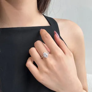 Close-up of elegant S925 sterling silver ring with pear-cut zircon on woman's hand.