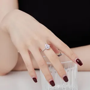 Elegant silver ring with a large pear-cut zircon stone shown on a woman's hand.
