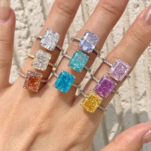 Close-up of multiple sterling silver rings featuring colorful radiant cut zircon stones on hand