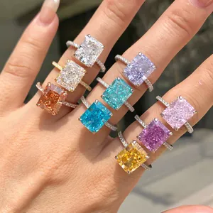 Macro detail of various sparkling radiant cut colored zircon rings on a lady's hand