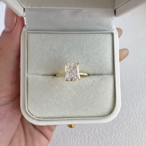 Detailed macro view of an elegant radiant cut simulated diamond ring in a white gift box.